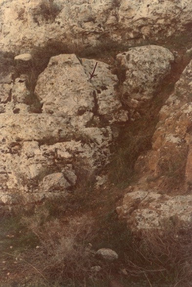 Large cleavage on left side of sealed cave entrance